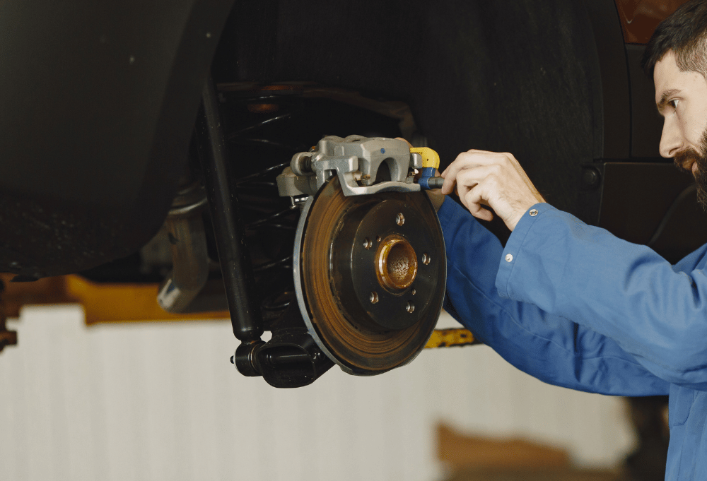 Technician replacing brake pads at Saguaro Alignment and Brakes in Phoenix, AZ